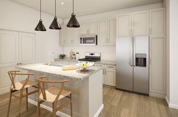 a kitchen with white cabinets and a marble counter top